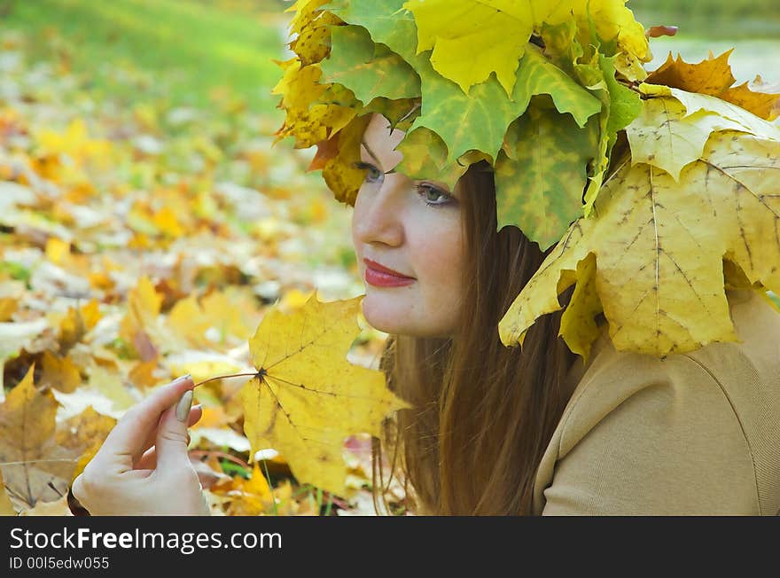 Portrait of the girl in a wreath from maple leaves