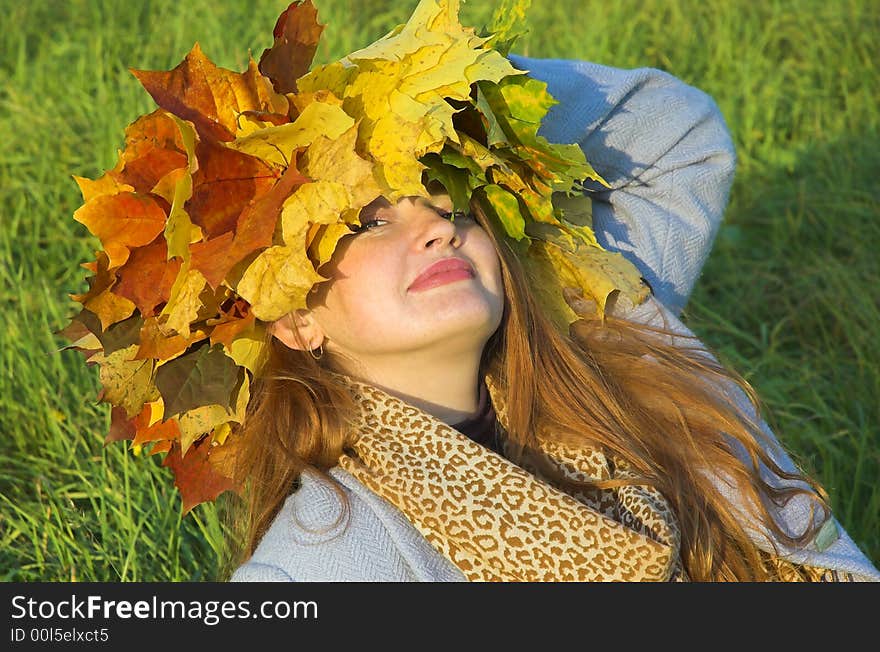 Portrait of the girl in a wreath from maple leaves