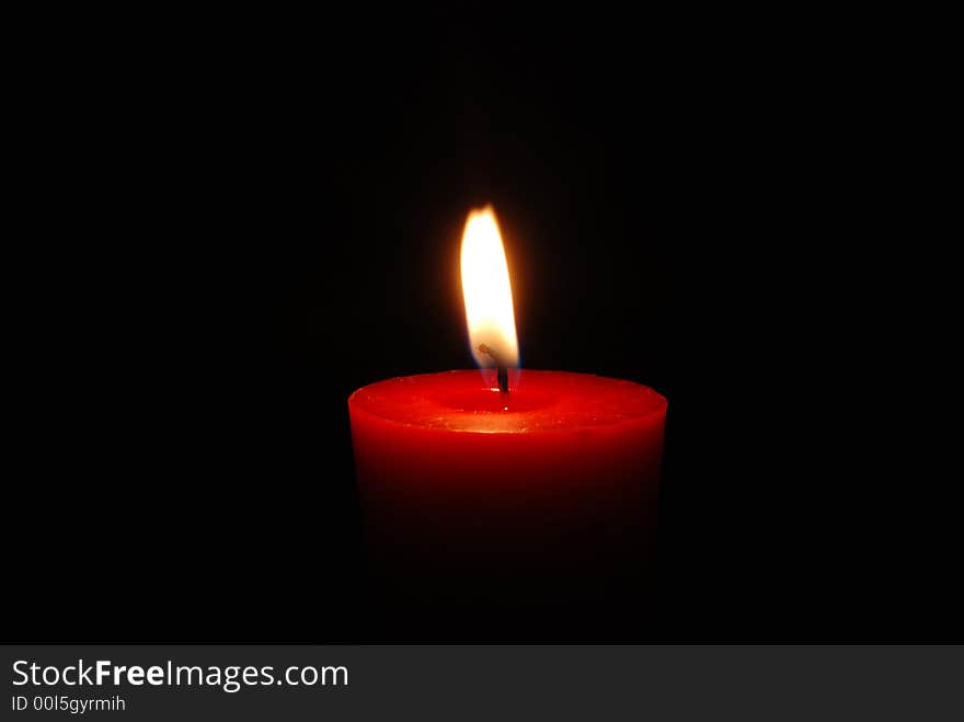 Red condle, flame, black background. Red condle, flame, black background