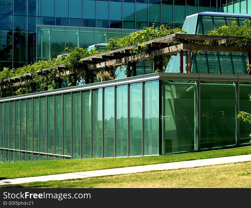 A shot of a glass building at the corner. A shot of a glass building at the corner.