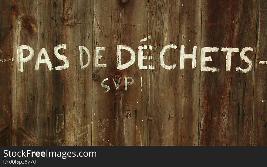 Writing on fence reading Pas De Dechets SVP!