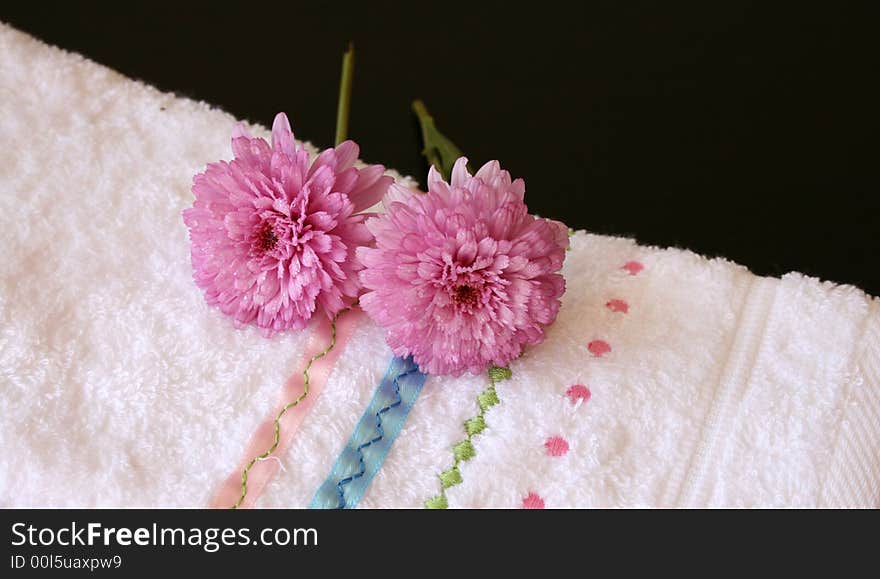 Plush pink flowers on an embroided hand towel