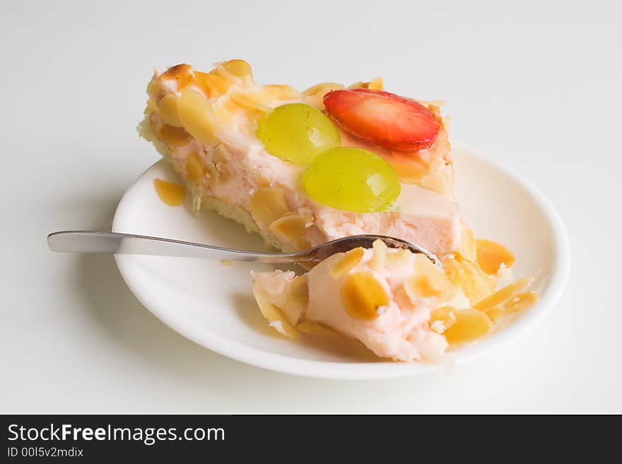 Fruit and yogurt cake with spoon nearby. Fruit and yogurt cake with spoon nearby