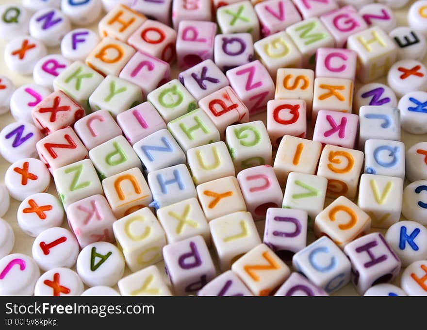 Small Colorful letters on different white shapes