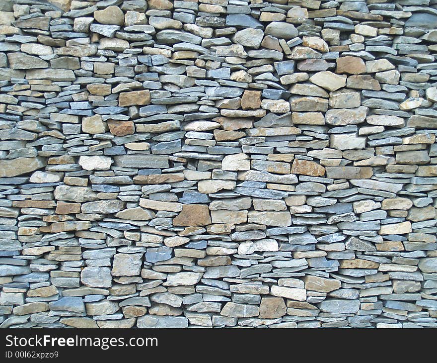 Horizontal view of a layered, sandstone exterior wall building facade. A close up of a brick wall which can be used as background. Horizontal view of a layered, sandstone exterior wall building facade. A close up of a brick wall which can be used as background.