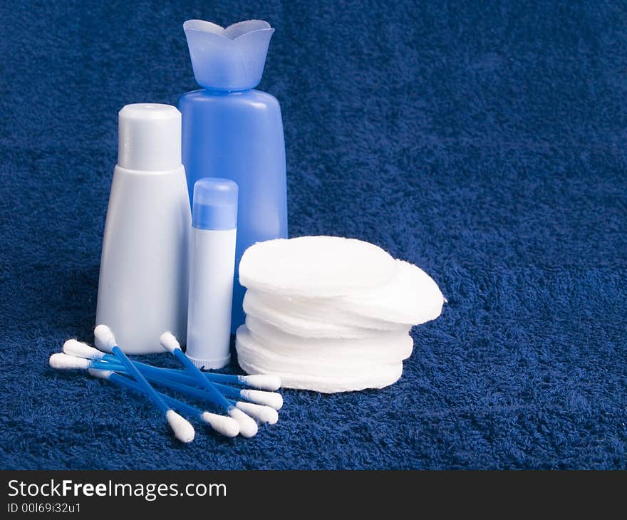 Toiletries and cosmetics on the blue towel