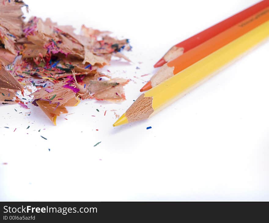 Coloured pencils and shavings on a white background