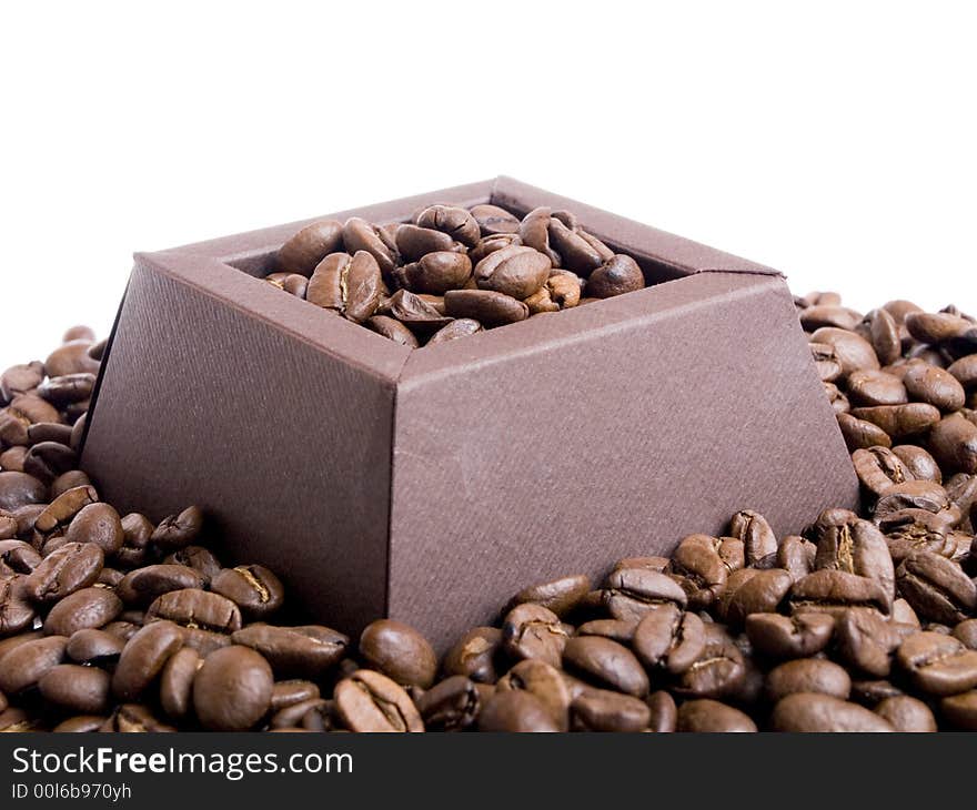 Coffee beans in the brown box on the white background