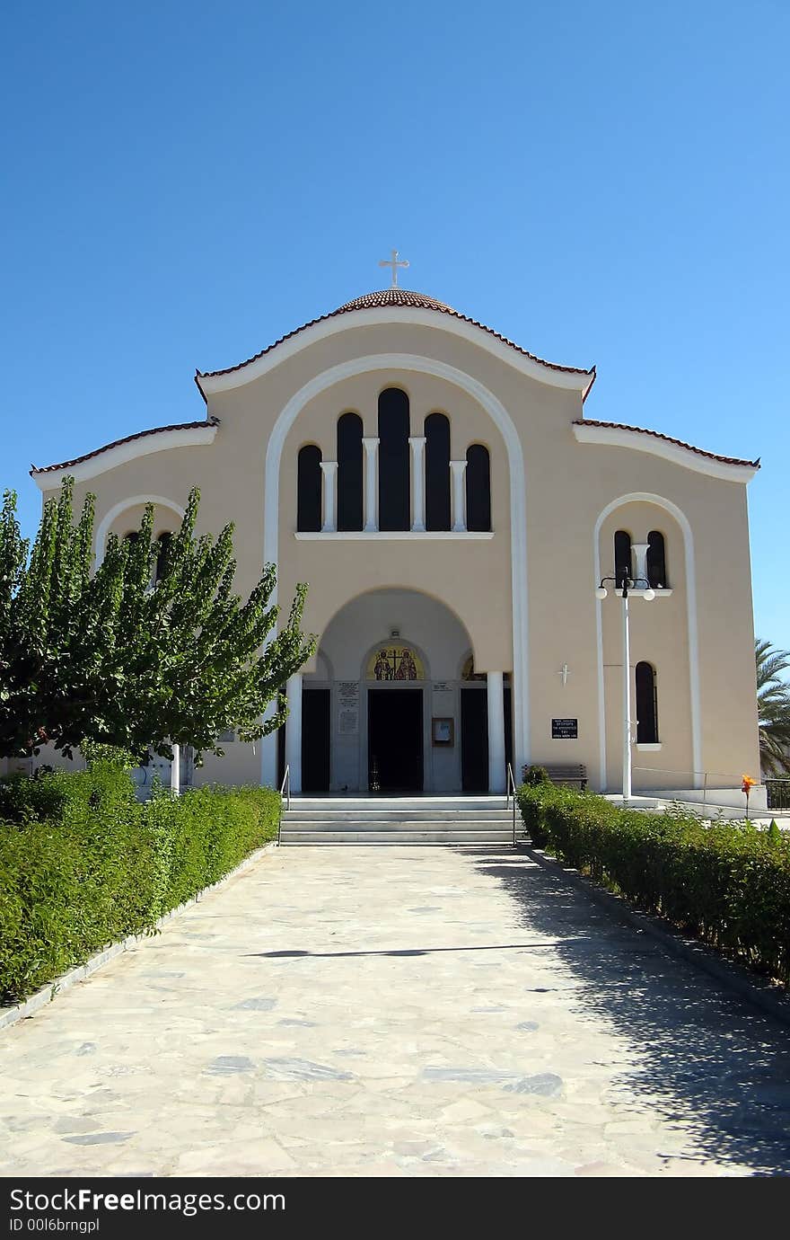 A big Greek Christian orthodox church in a garden under the clear sky. A big Greek Christian orthodox church in a garden under the clear sky