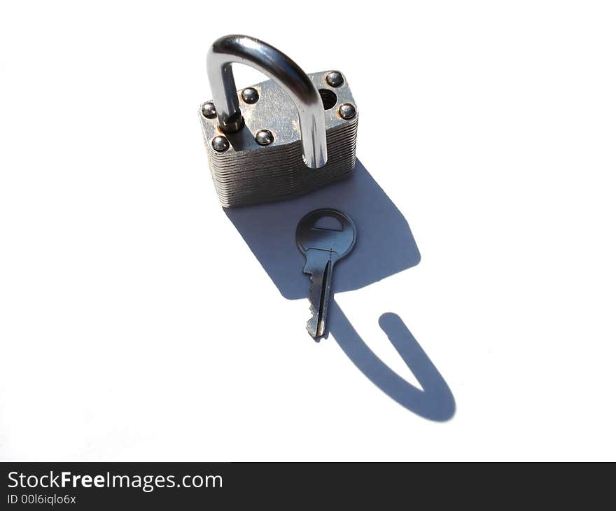 An open padlock with key, isolated on white. An open padlock with key, isolated on white.