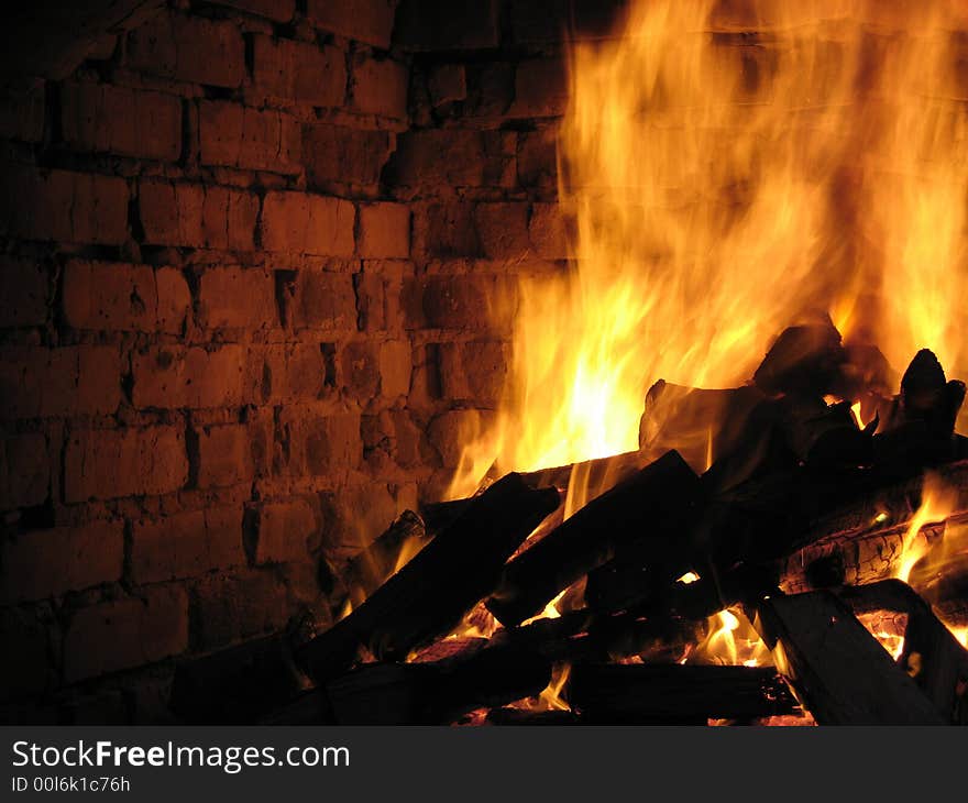 A blazing hot inferno in a crumbling fireplace. A blazing hot inferno in a crumbling fireplace