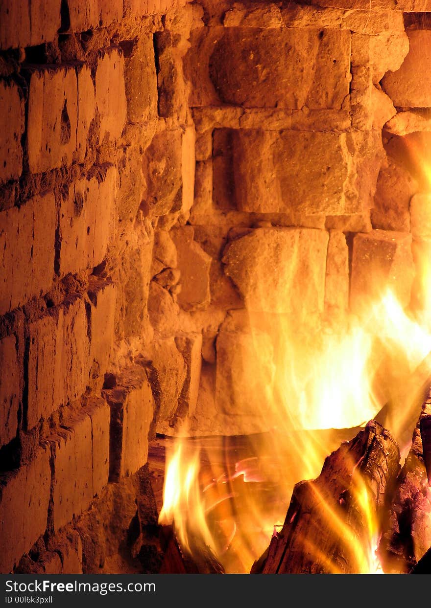 A blazing hot inferno in a crumbling fireplace. A blazing hot inferno in a crumbling fireplace