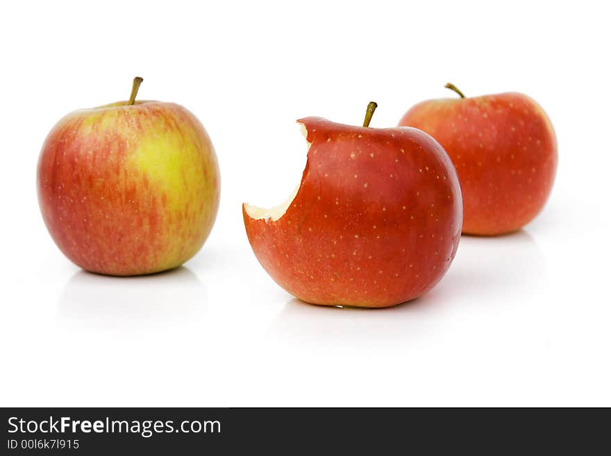 Fresh Three Red Apple on Light Background (one apple is premorsed)