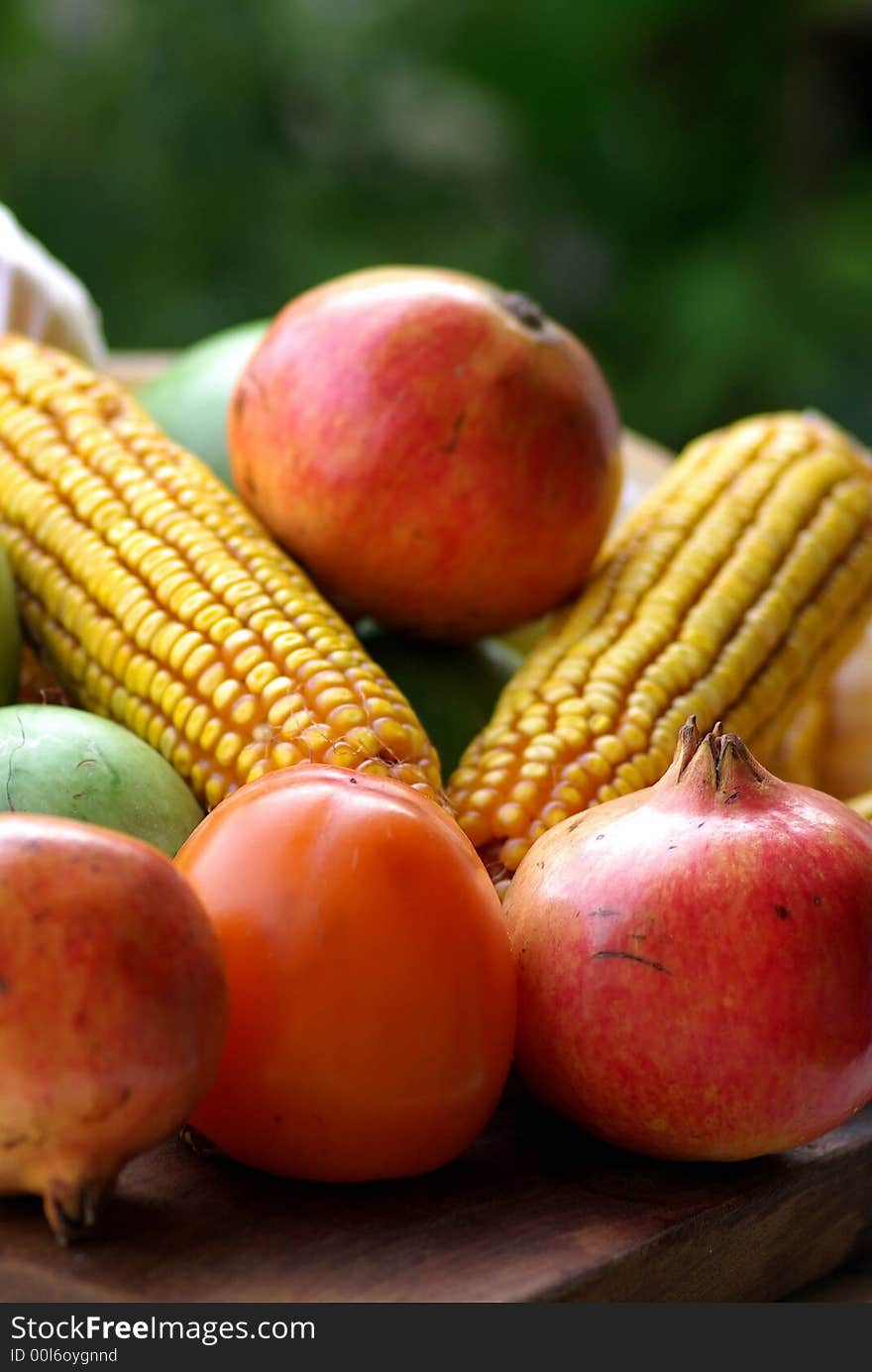 Yellow corn maize and red autumn fruits. Yellow corn maize and red autumn fruits