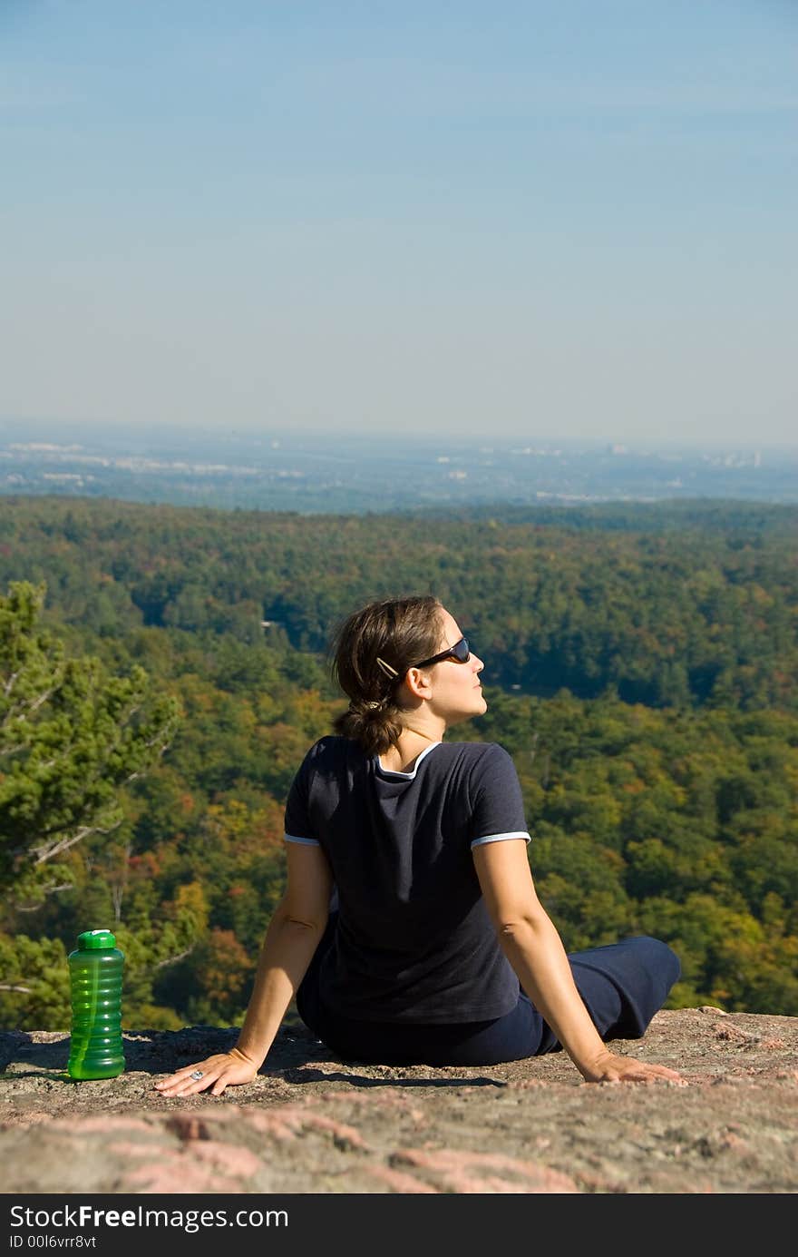 Sitting woman on top of a mountain. Sitting woman on top of a mountain