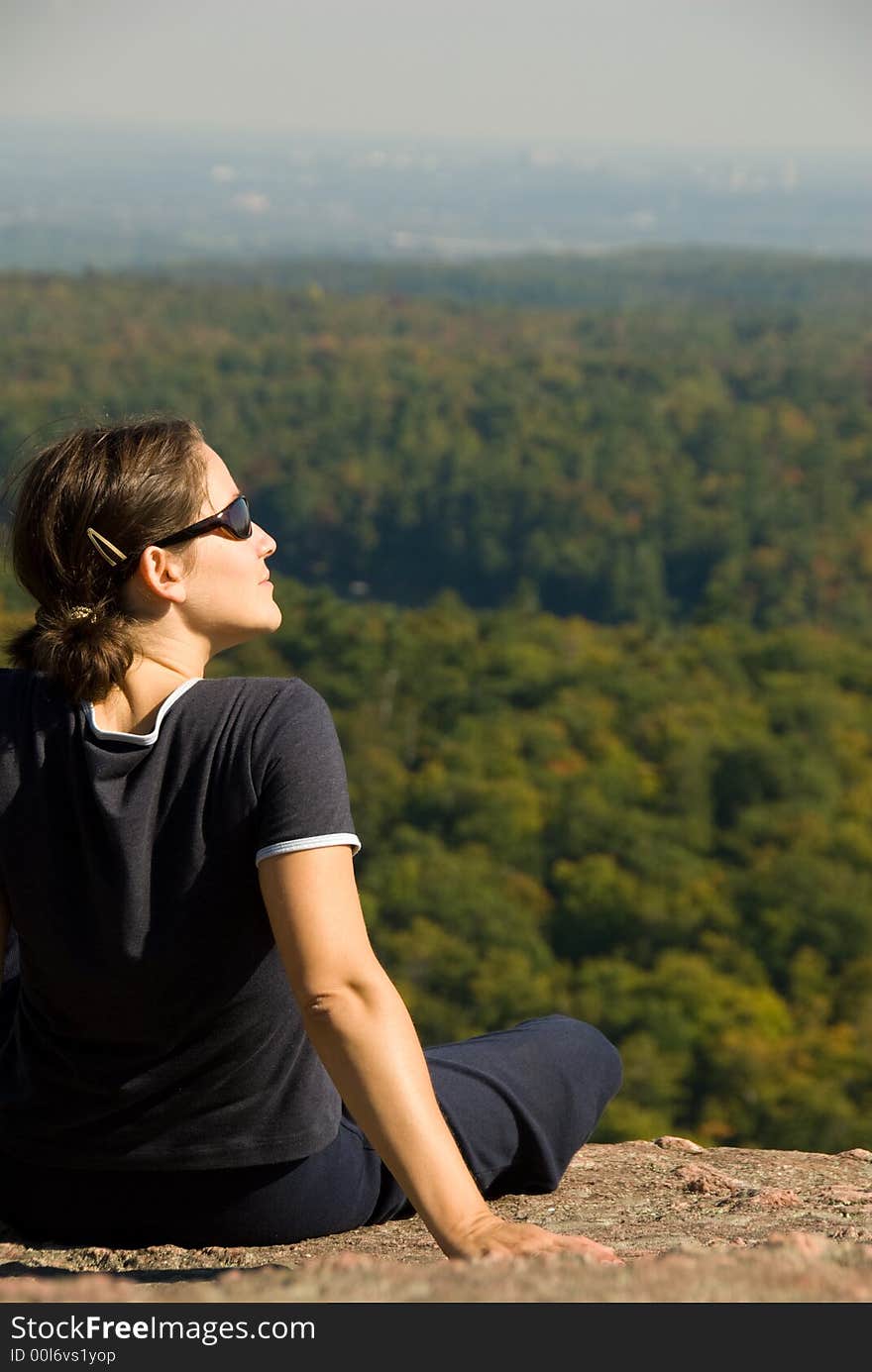 Sitting woman on top of a mountain. Sitting woman on top of a mountain