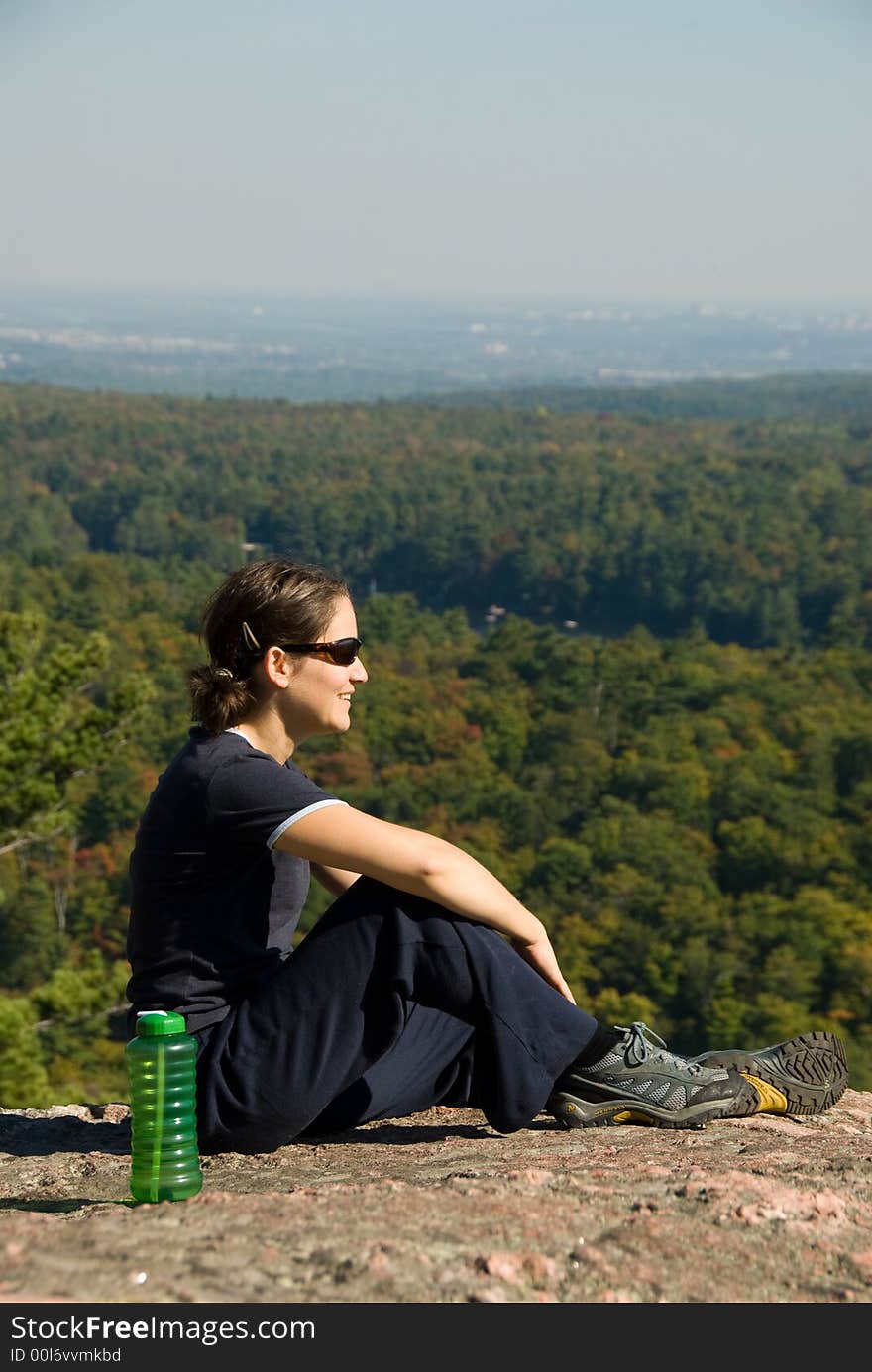 Sitting woman on top of a mountain. Sitting woman on top of a mountain