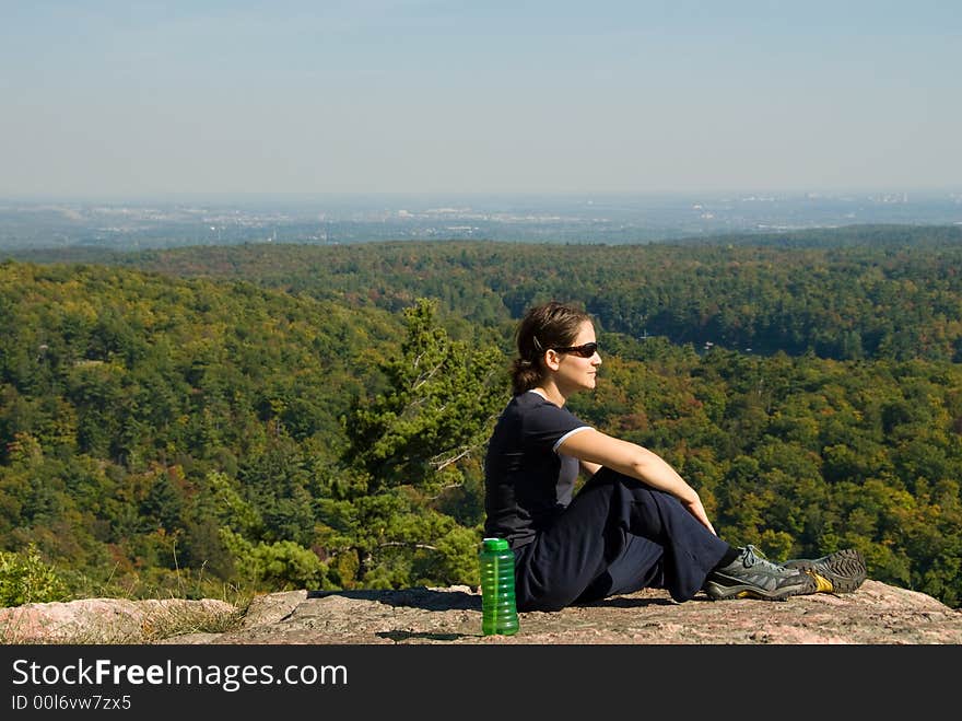 Sitting woman on top of a mountain. Sitting woman on top of a mountain