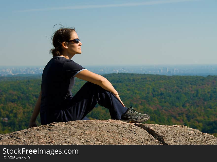 Sitting woman on top of a mountain. Sitting woman on top of a mountain