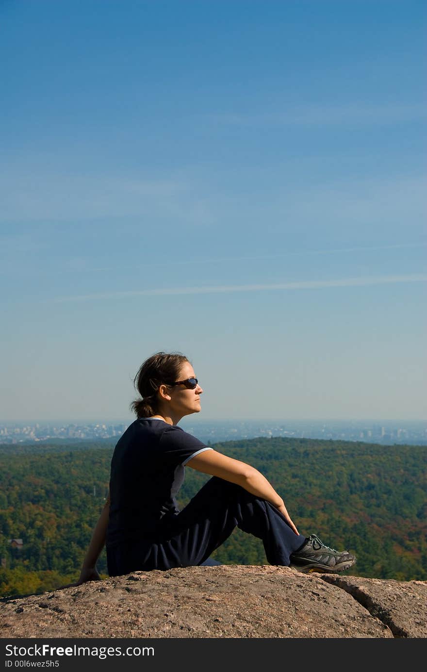 Sitting woman on top of a mountain. Sitting woman on top of a mountain