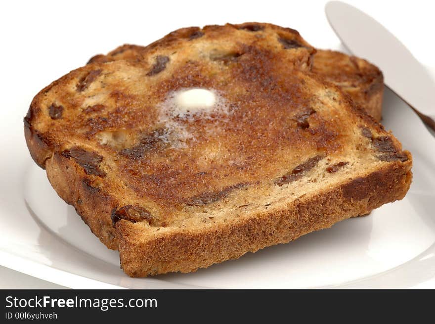 Toasted and buttered raisin bread perfectly browned. Toasted and buttered raisin bread perfectly browned.