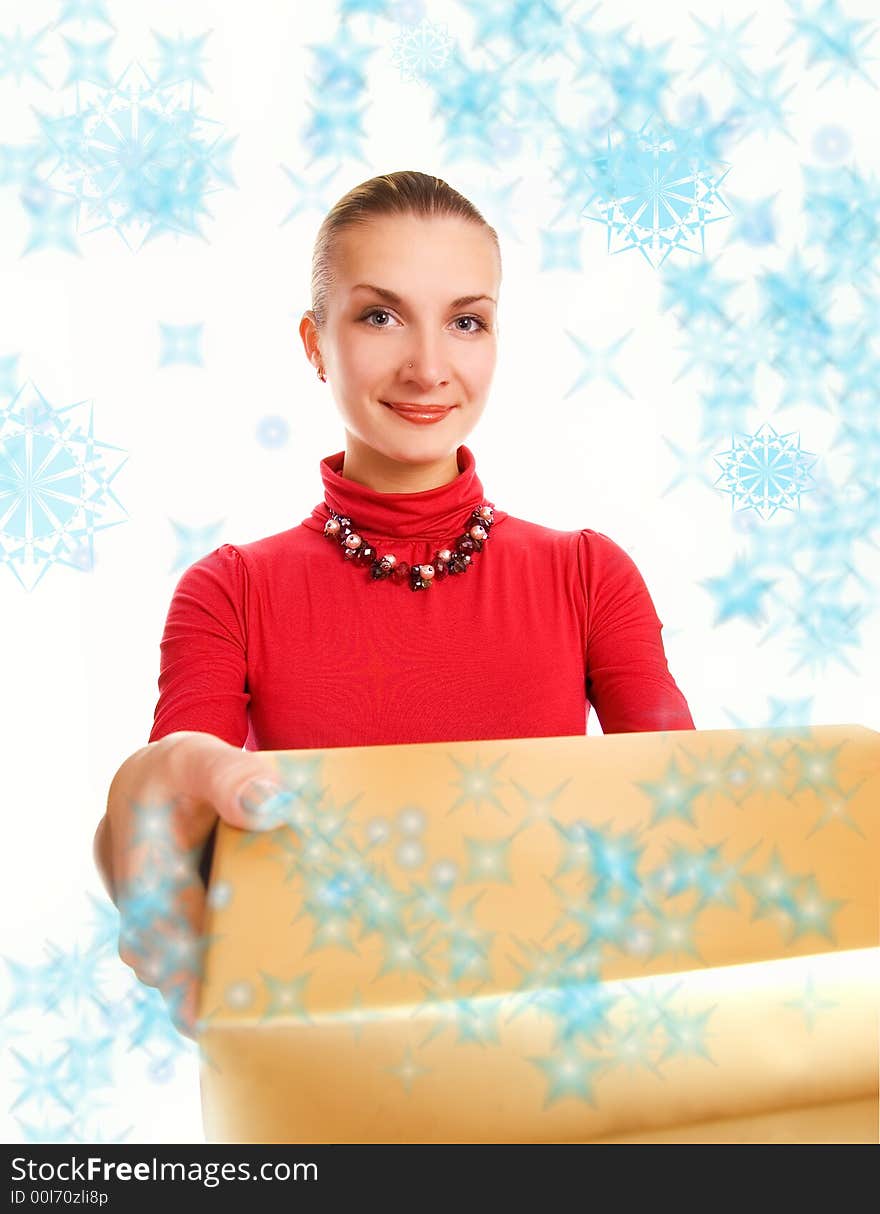 Beautiful blond girl with a gift box and magic snowflakes around her