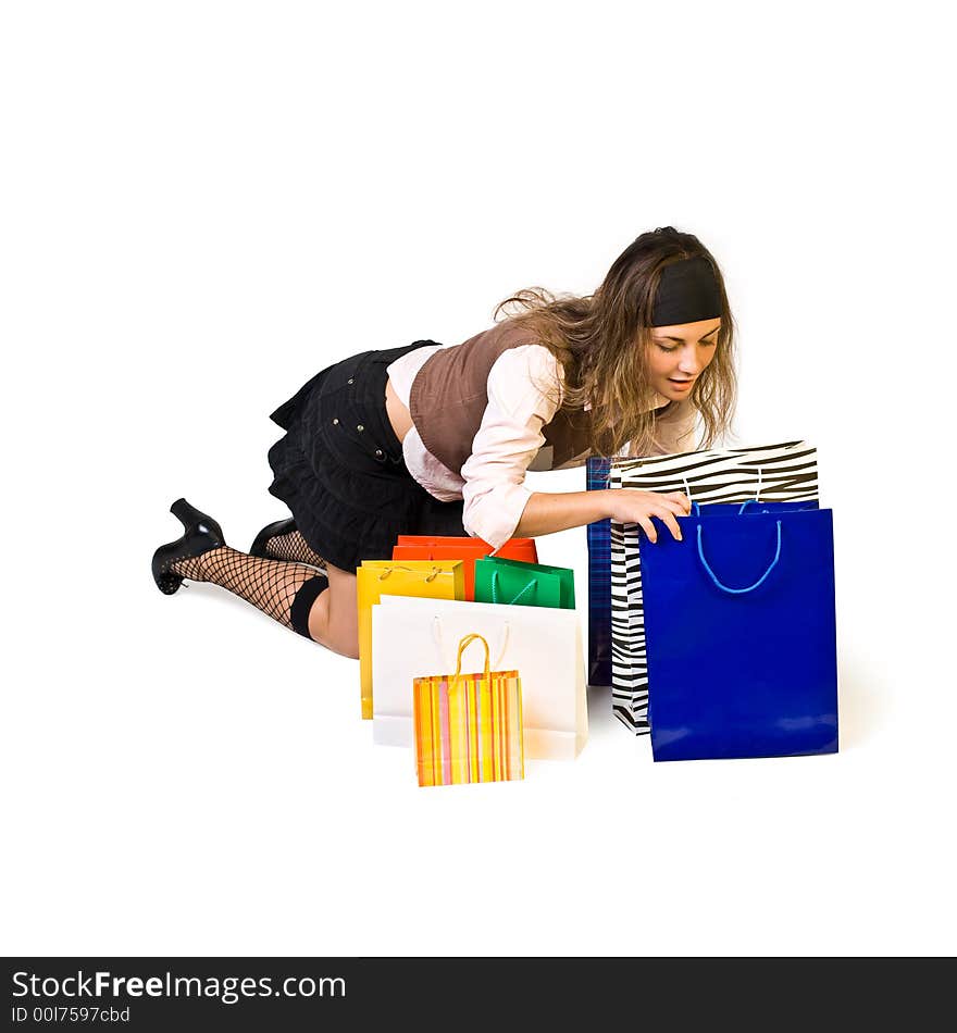 Beautiful girl looks in shoppingbag and smiles