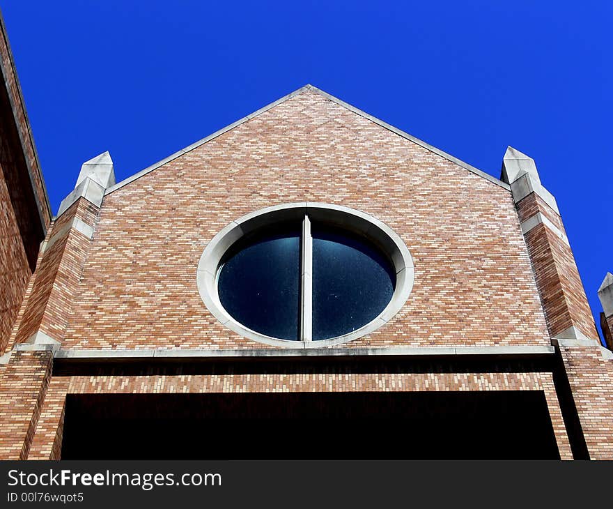 A shot of a building with a circle type window. A shot of a building with a circle type window.