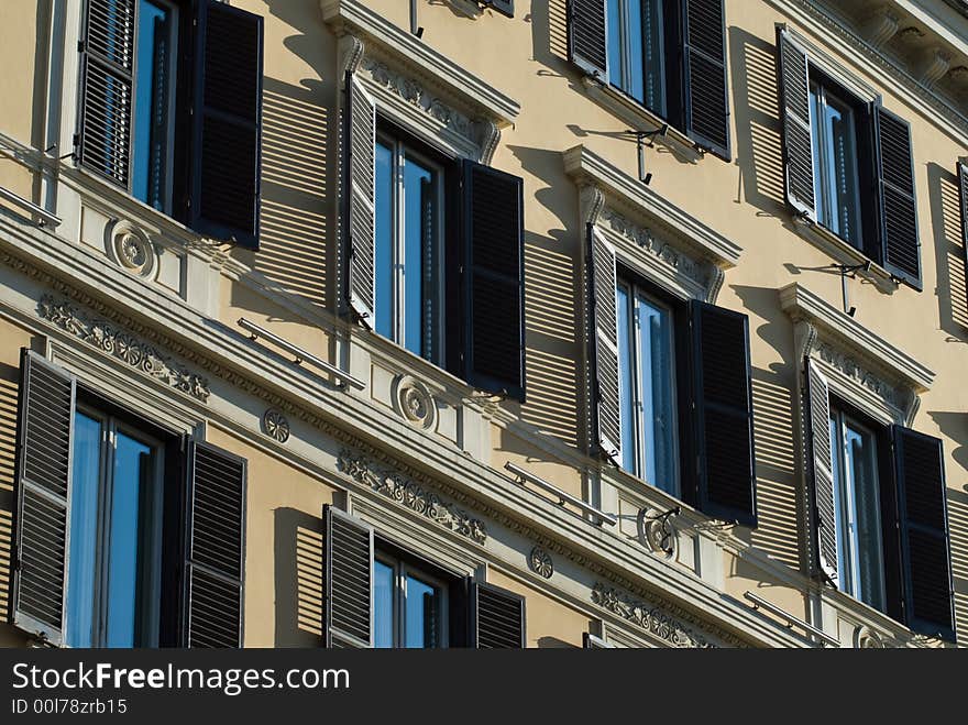 Ornamented facade of  building with shadows. Ornamented facade of  building with shadows