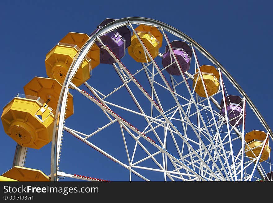 Colorful Ferris wheel on a blue sky