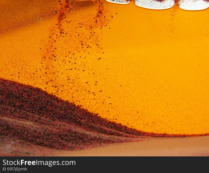 Toy with sand inside, orange background, sand storm