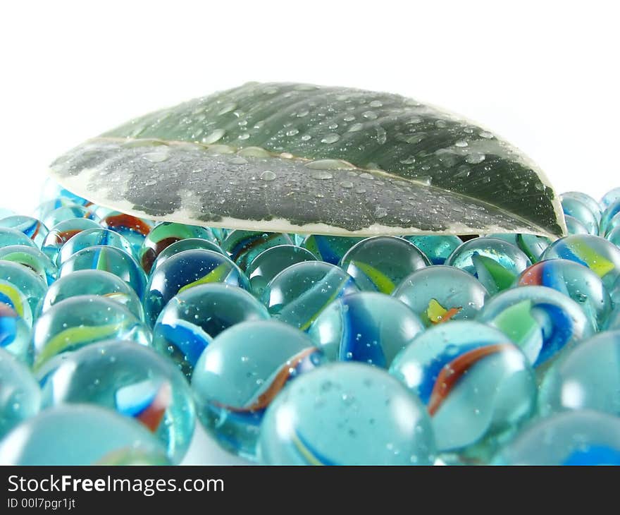 Composition from nature series: wet green leaf on glass balls