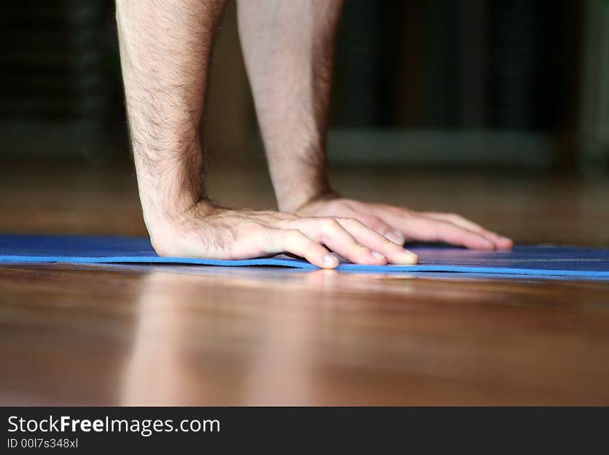 The hands of an athlete while makes the push-up. The hands of an athlete while makes the push-up