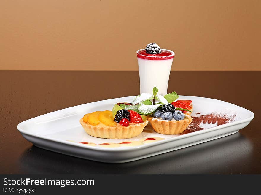 Mixed desert plate with panacotta and summer berries