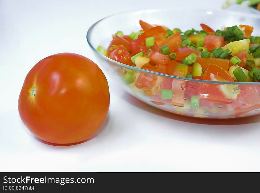 Tomato and salad with an onions close up. Tomato and salad with an onions close up