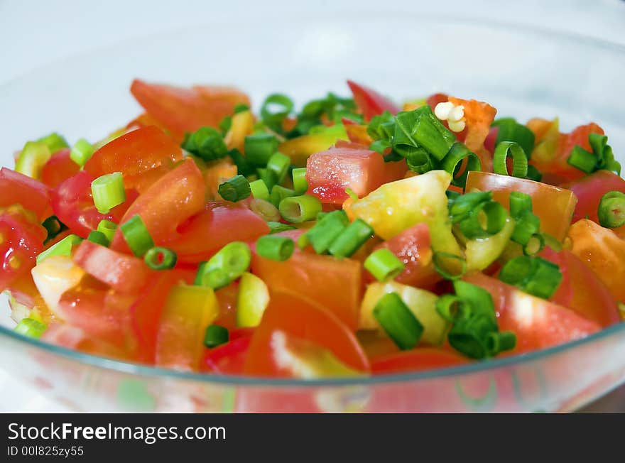 Salad from tomatoes, cucumbers, pepper and a green onions close up. Salad from tomatoes, cucumbers, pepper and a green onions close up