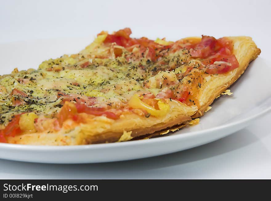 Piece of a pizza close up on a white background