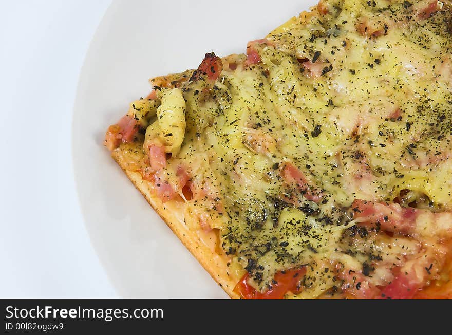 Piece of a pizza close up on a white background