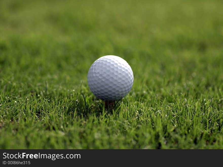 Golf ball on a tee in the Golf Course. Golf ball on a tee in the Golf Course.