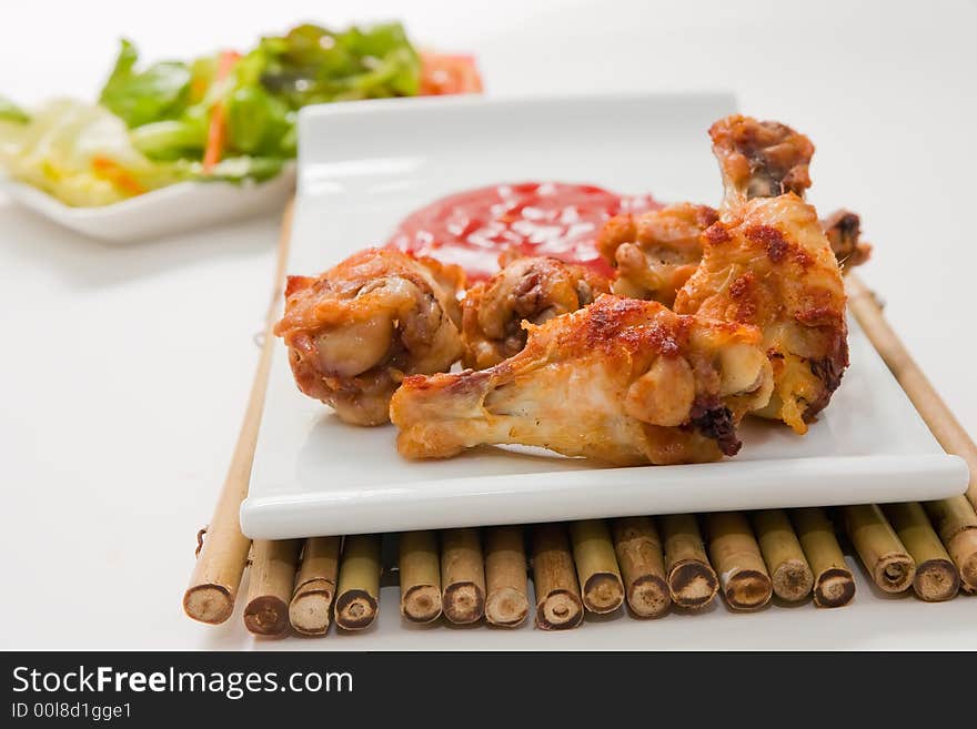 Hot spices buffalo wings with salad and chili sauce