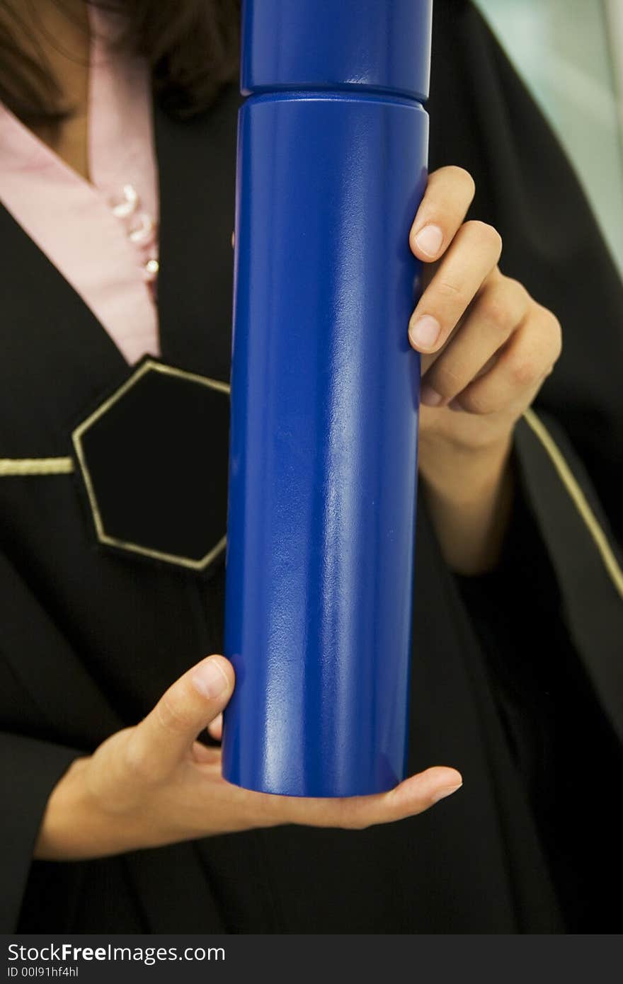 Student holding blue diploma in her hands