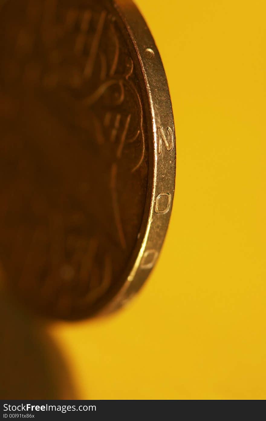 Close-up of coins on yellow background, macro (shallow DOF)