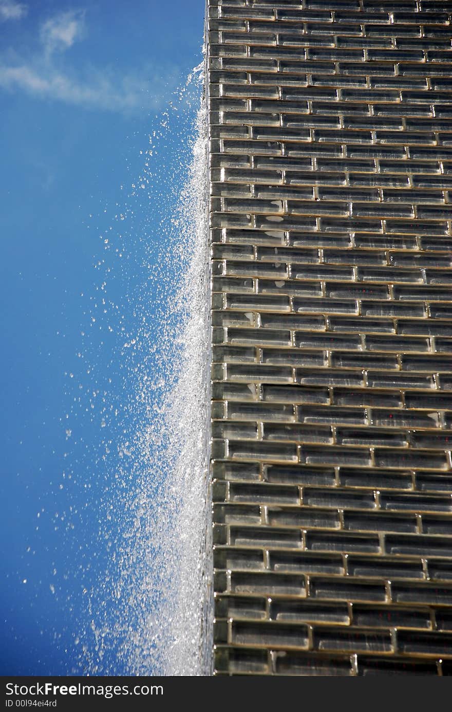 Running water on a wall at blue sky. Running water on a wall at blue sky.