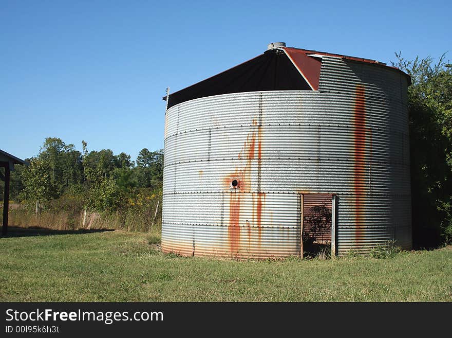 Rusty old Crop Storage bin with blue sky