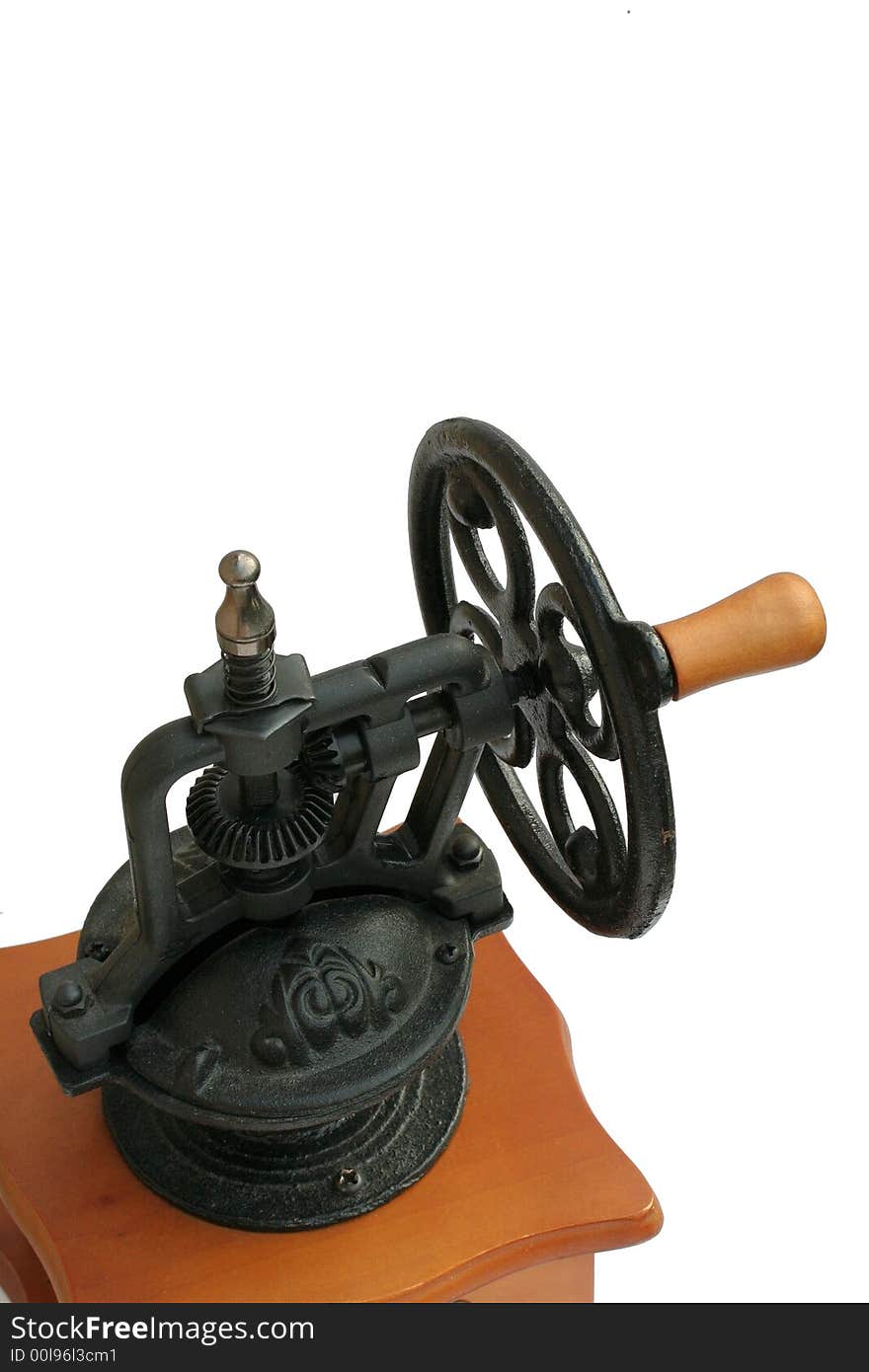 A detail of a heavy cast-iron grinding mechanism on top of a coffee grinder, isolated.