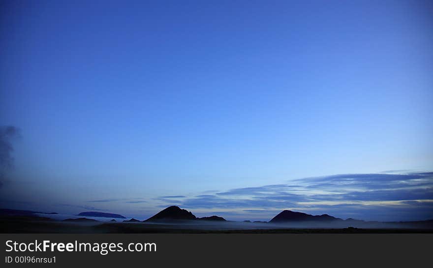 Silhouetted misty landscape