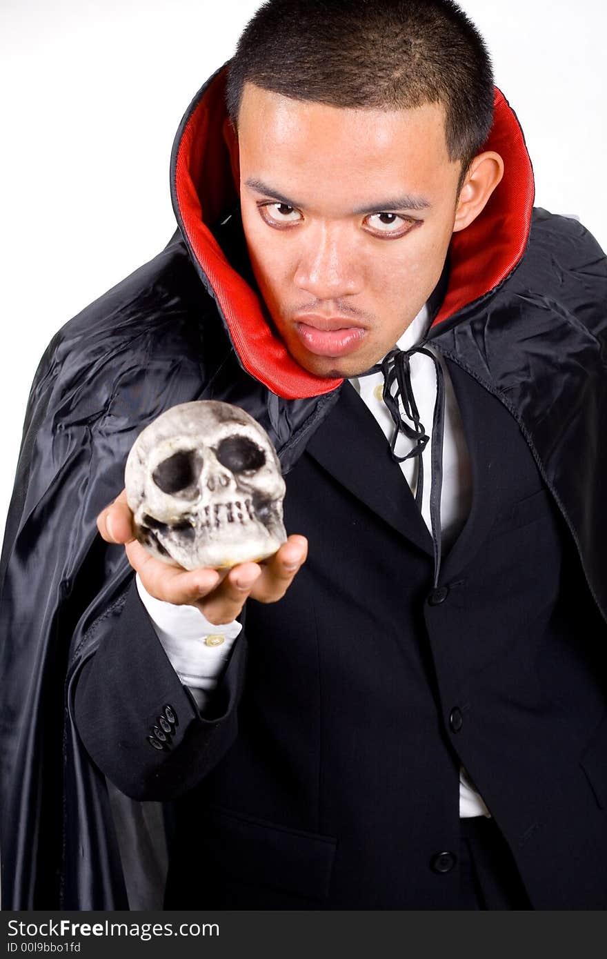 Scary man holding dead skull on his hand.