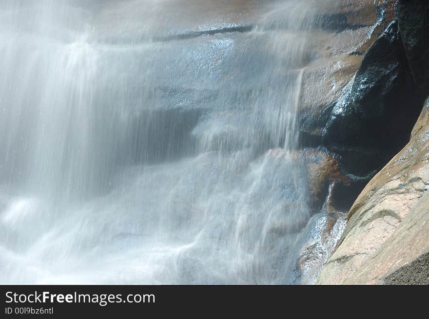 A waterfall in the mountain , China. A waterfall in the mountain , China.