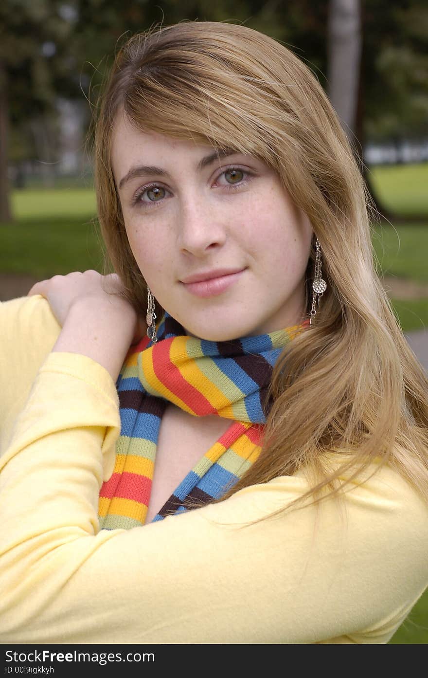 Young beautiful teen outdoors at the park. Has a fall or winter season look.