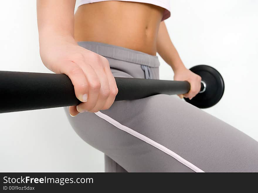 Closeup of a woman's stomach, holding some weights. Closeup of a woman's stomach, holding some weights.